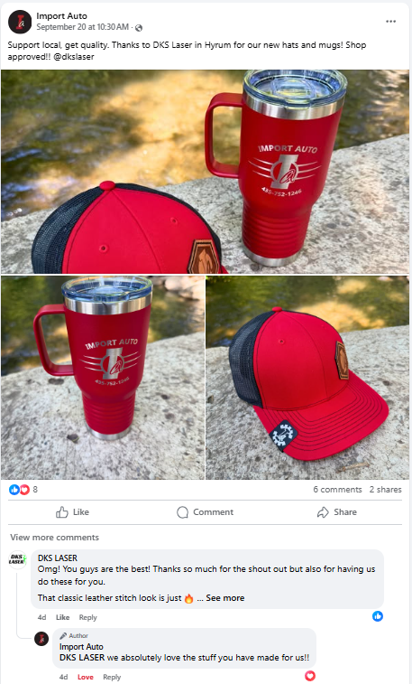 A red and black trucker hat and a red tumbler with a silver lid and handle, both branded with 'Import Auto,' are placed on a rock near a body of water.