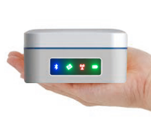 Portable medical device with illuminated status indicators held in a person's hand
