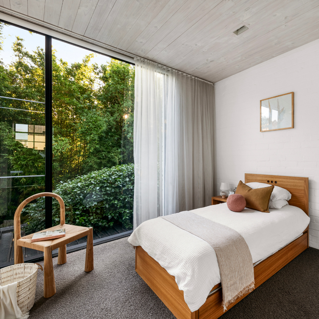 Partially styled bedroom at 53 Little Smith Street, Fitzroy with a garden outlook