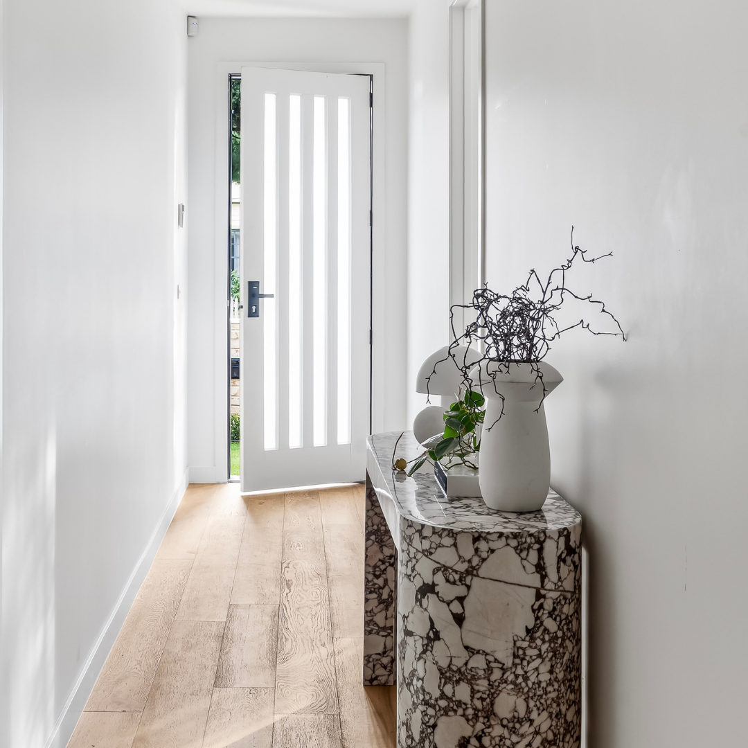 Home staging of an entry hallway in a Preston townhouse designed to create a strong first impression.