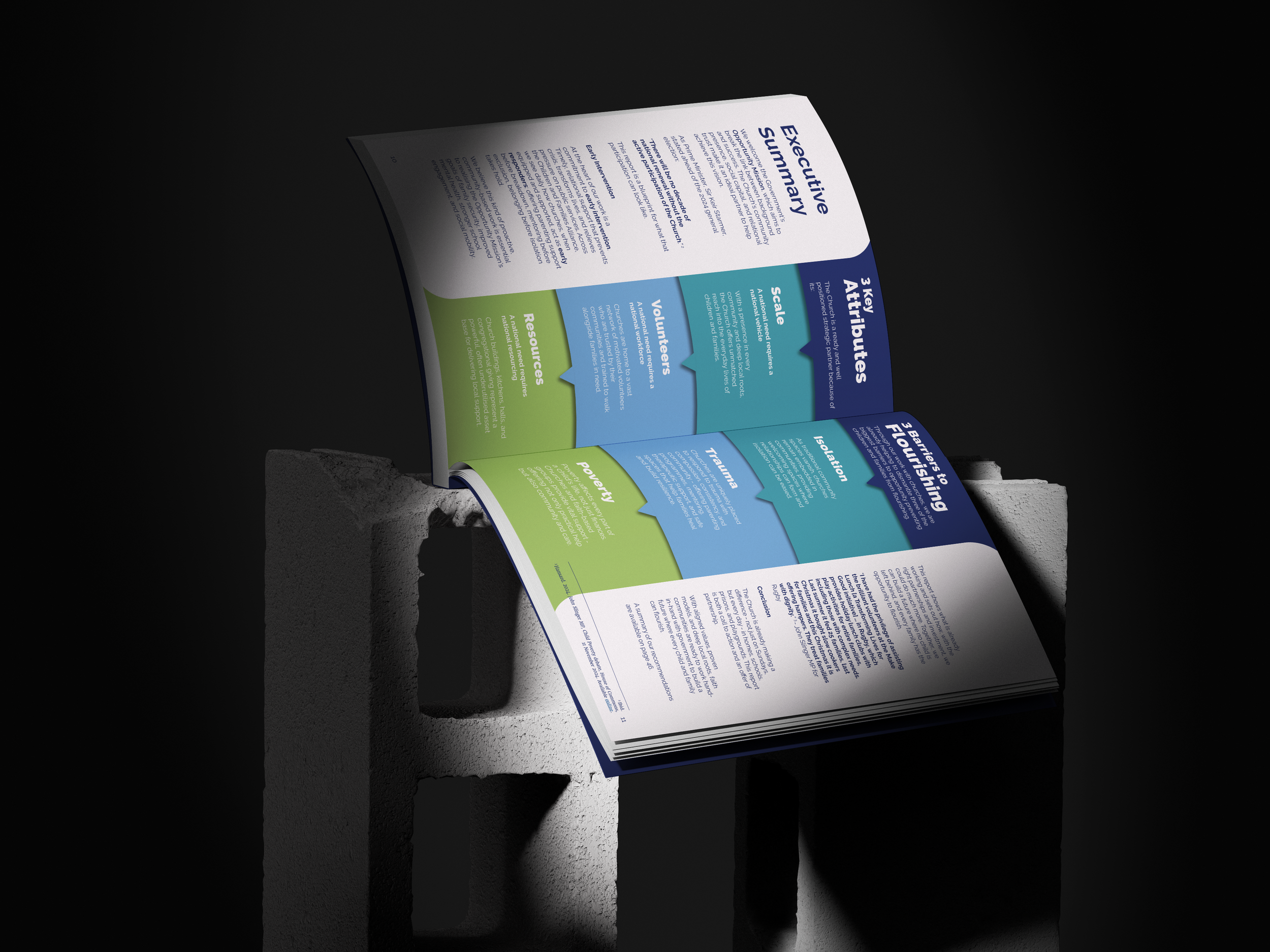 Open brochure with blue, green, and white sections resting on a concrete block against a black background.