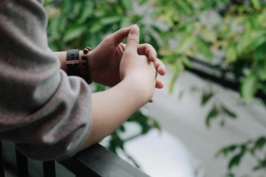 Relaxing hands on a railing