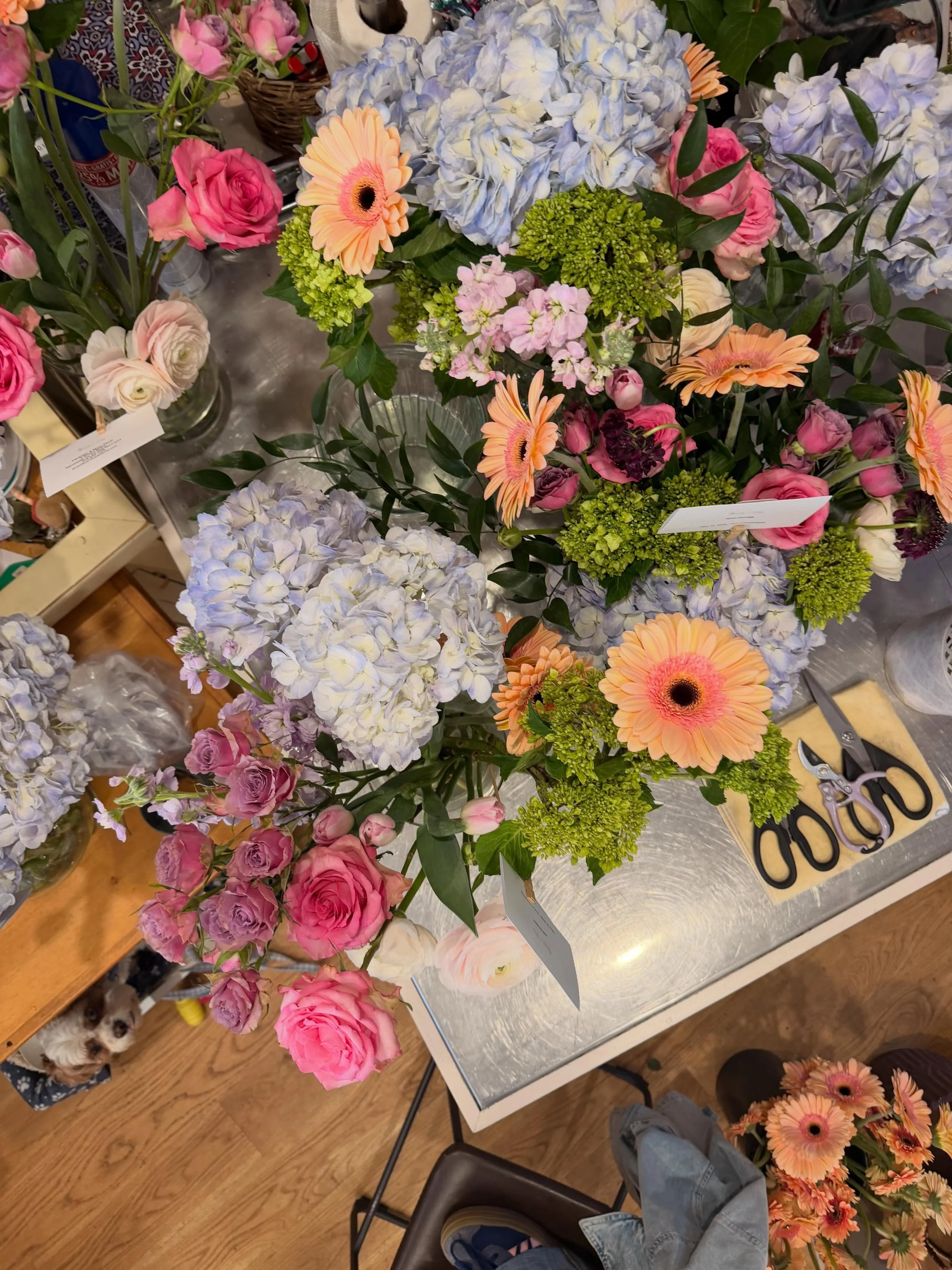 The girls (Hazel included 🐶) are hard at work making beautiful bouquets ($125) and arrangements ($150) to make Mother&rsquo;s Day seemless for you all! Call us or stop by to make mom&rsquo;s Mother&rsquo;s Day special!