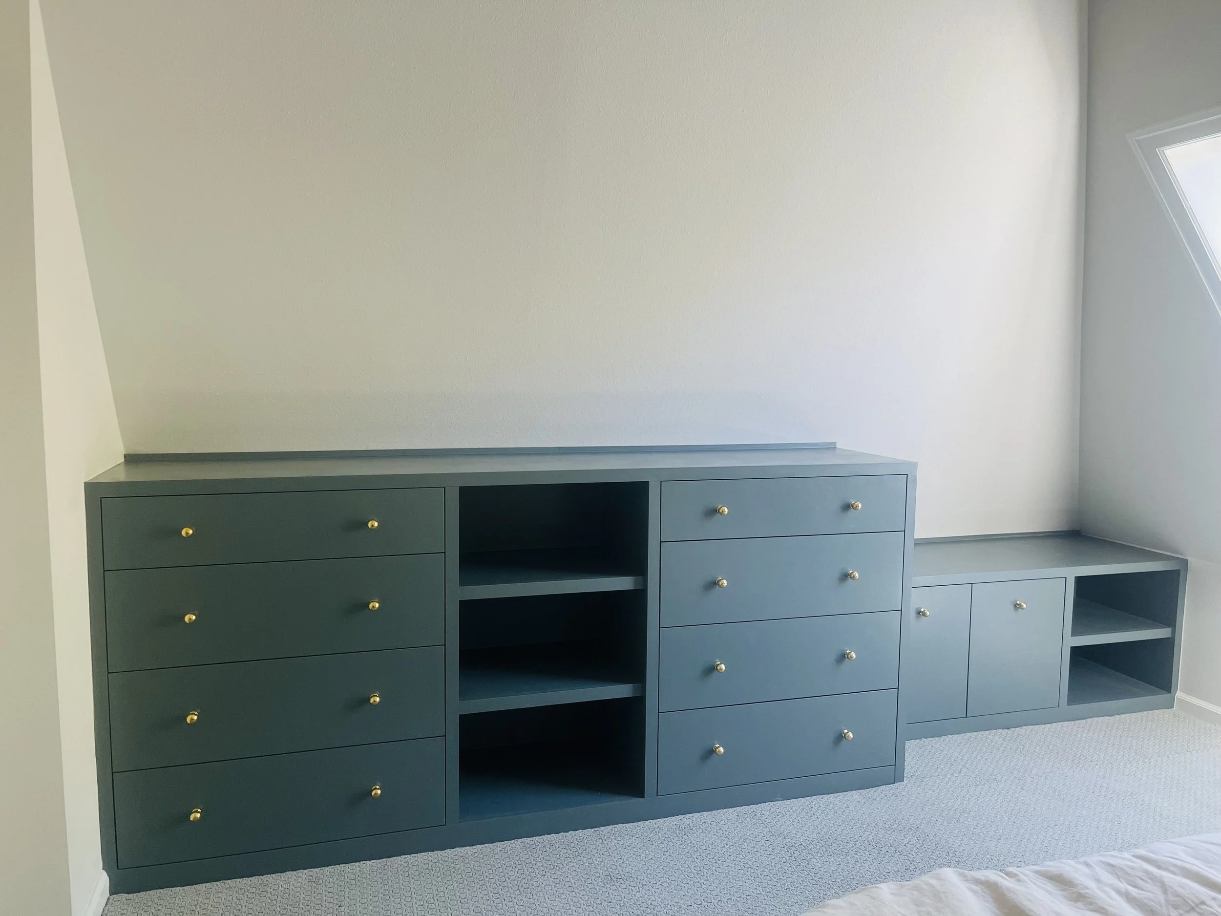 Wall to wall built-in in this funky PDX attic bedroom. Designed by Copeland and Co. to optimize storage in an otherwise un-usable nook of the room.