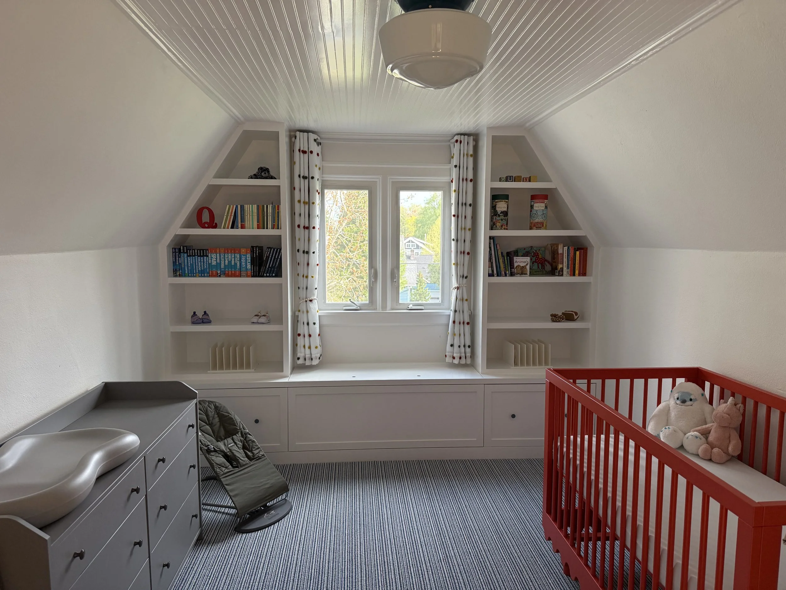 Built-in bench seat with bookshelves for this adorable nursery! 