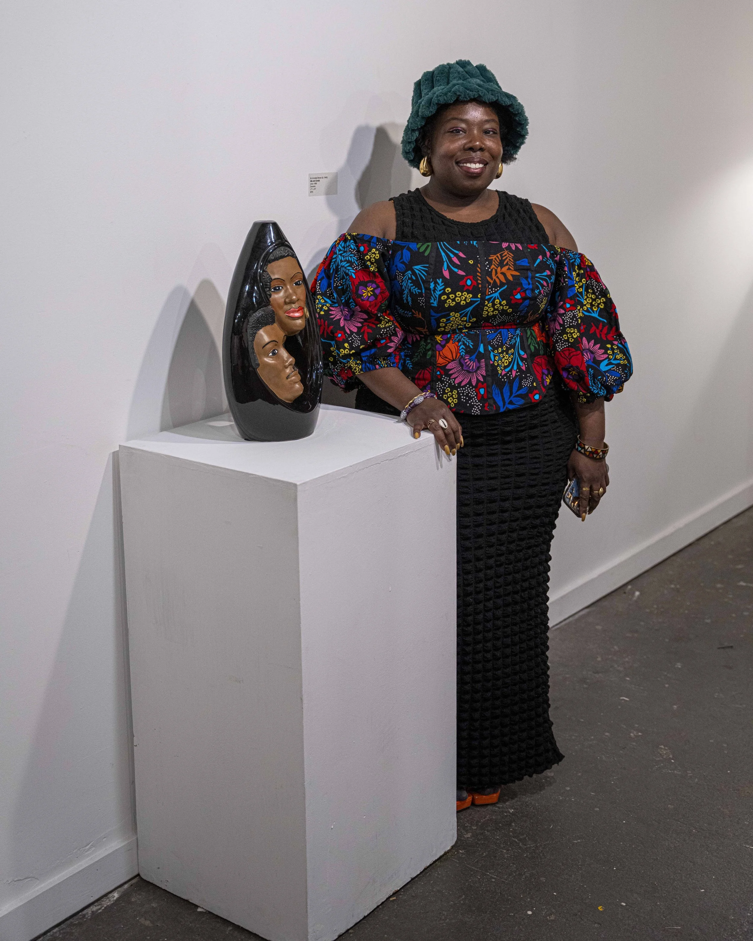 Camisha poses next to her sculpture