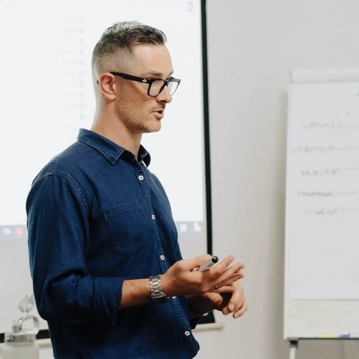 SteHan Botha presenting and facilitating a brand strategy workshop in front of a live audience in a conference room..jpg