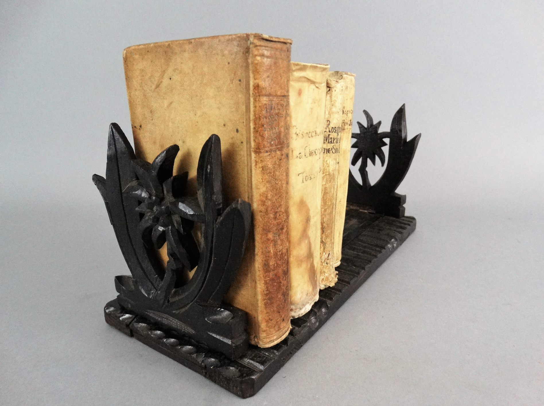 An early 20th-century carved telescoping Black Forest book slide. It has carved palm trees on both ends. Located in Austin, Texas.