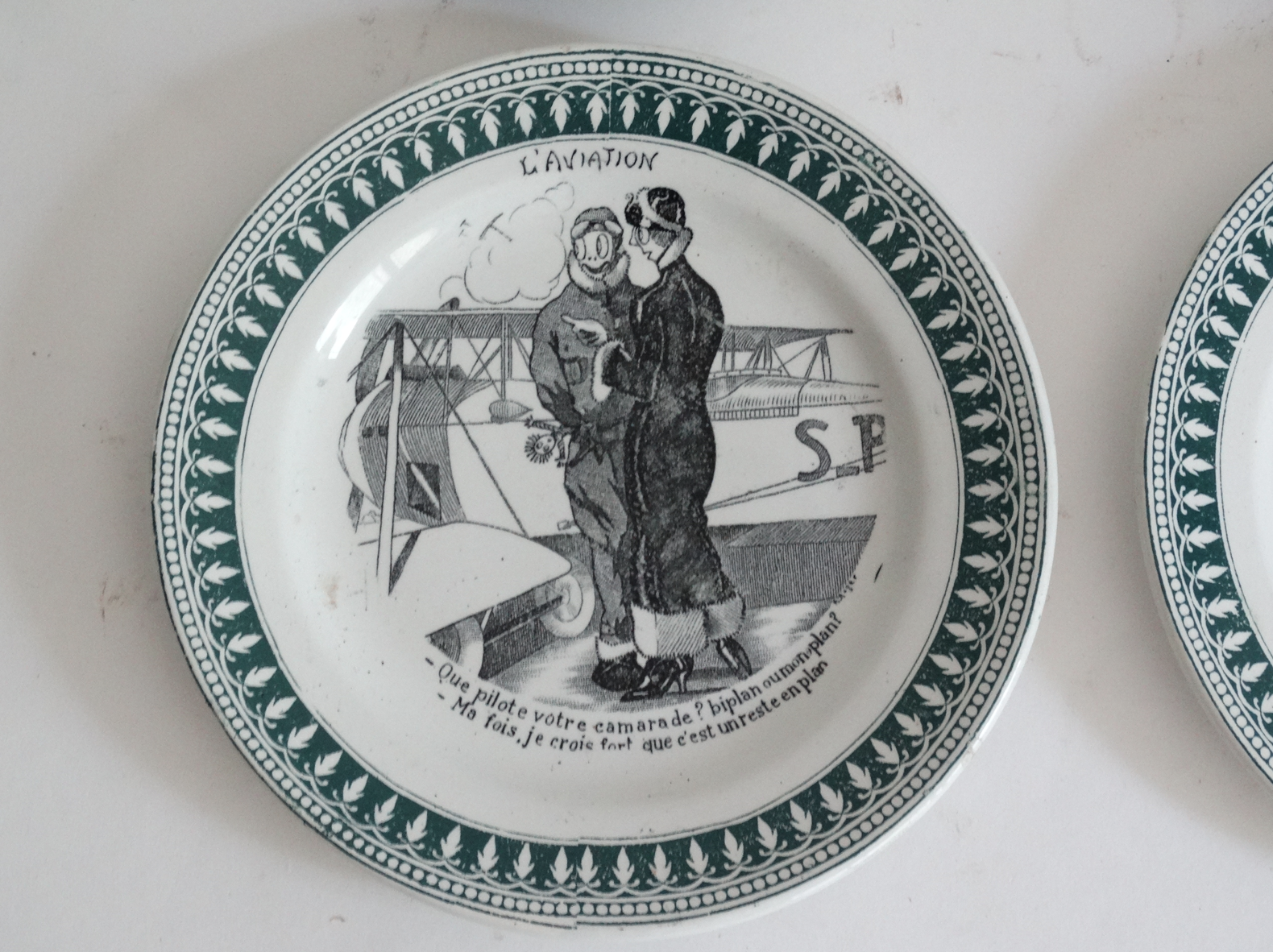 Four French faience sporting plates from St Amand factory, circa 1920. Includes Le Tennis, La Course Pied, La Boxe, L’Aviation, and l'Automobilisme. Located in Austin, Texas.