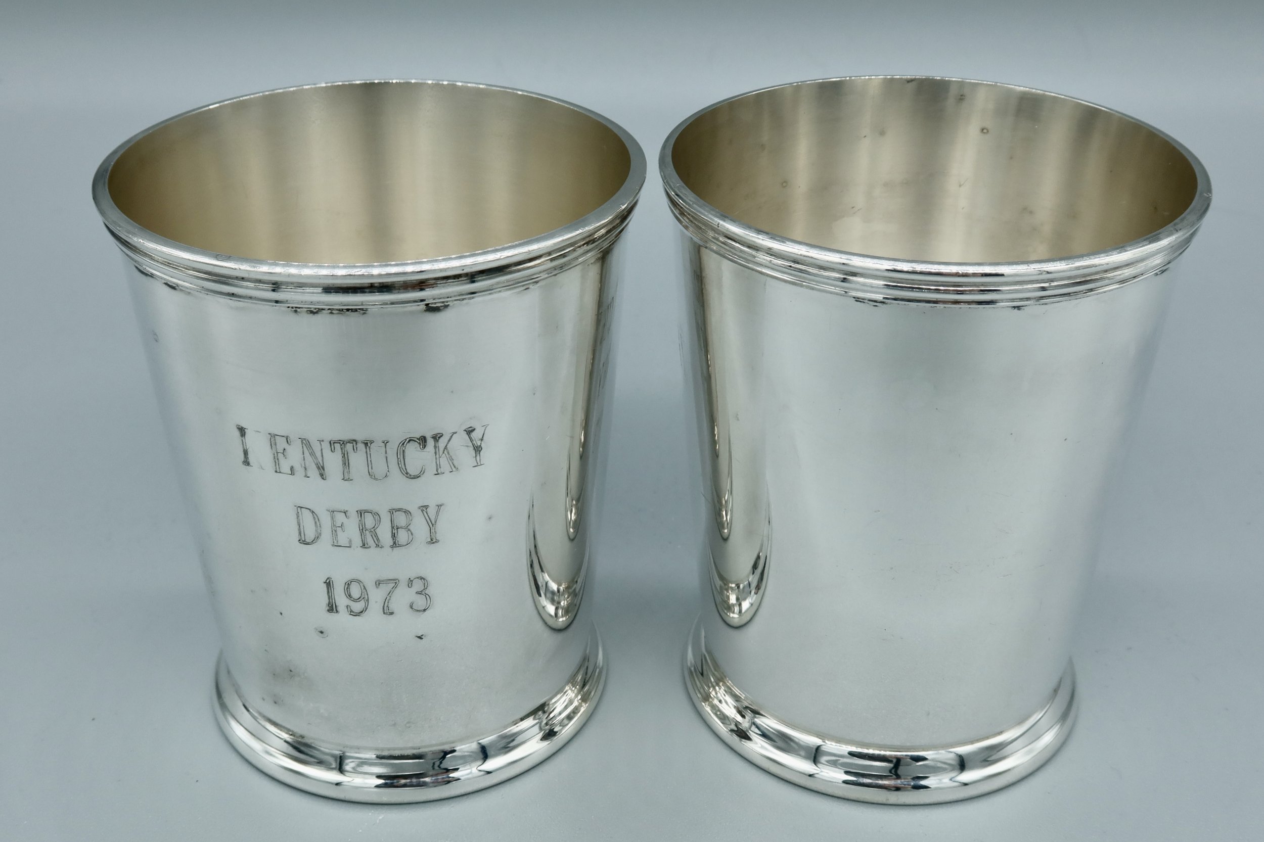 Pair of silverplate mint julep cups engraved “KENTUCKY DERBY 1973” on the exterior, with maker’s mark on the underside. Located in Austin, Texas.
