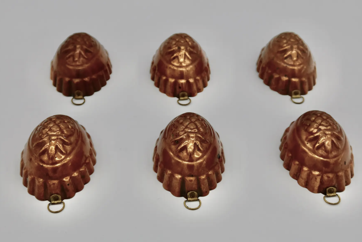 Set of early 1920's French copper molds. They are tin lined, each with its original hanger. Located in Austin, Texas.