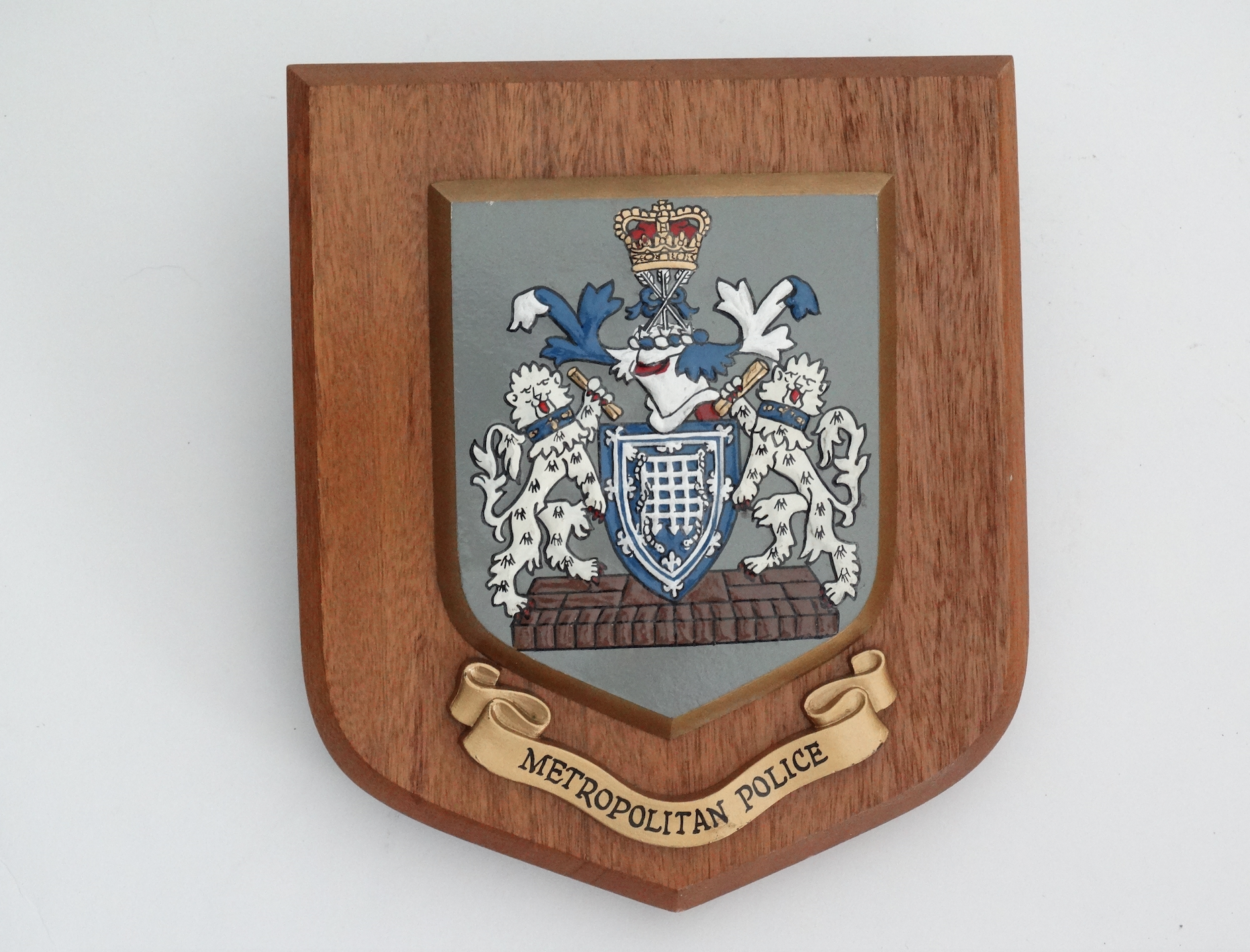 Circa 1950, an English Metropolitan Police, United Kingdom crested wall plaque. Located in Austin, Texas.