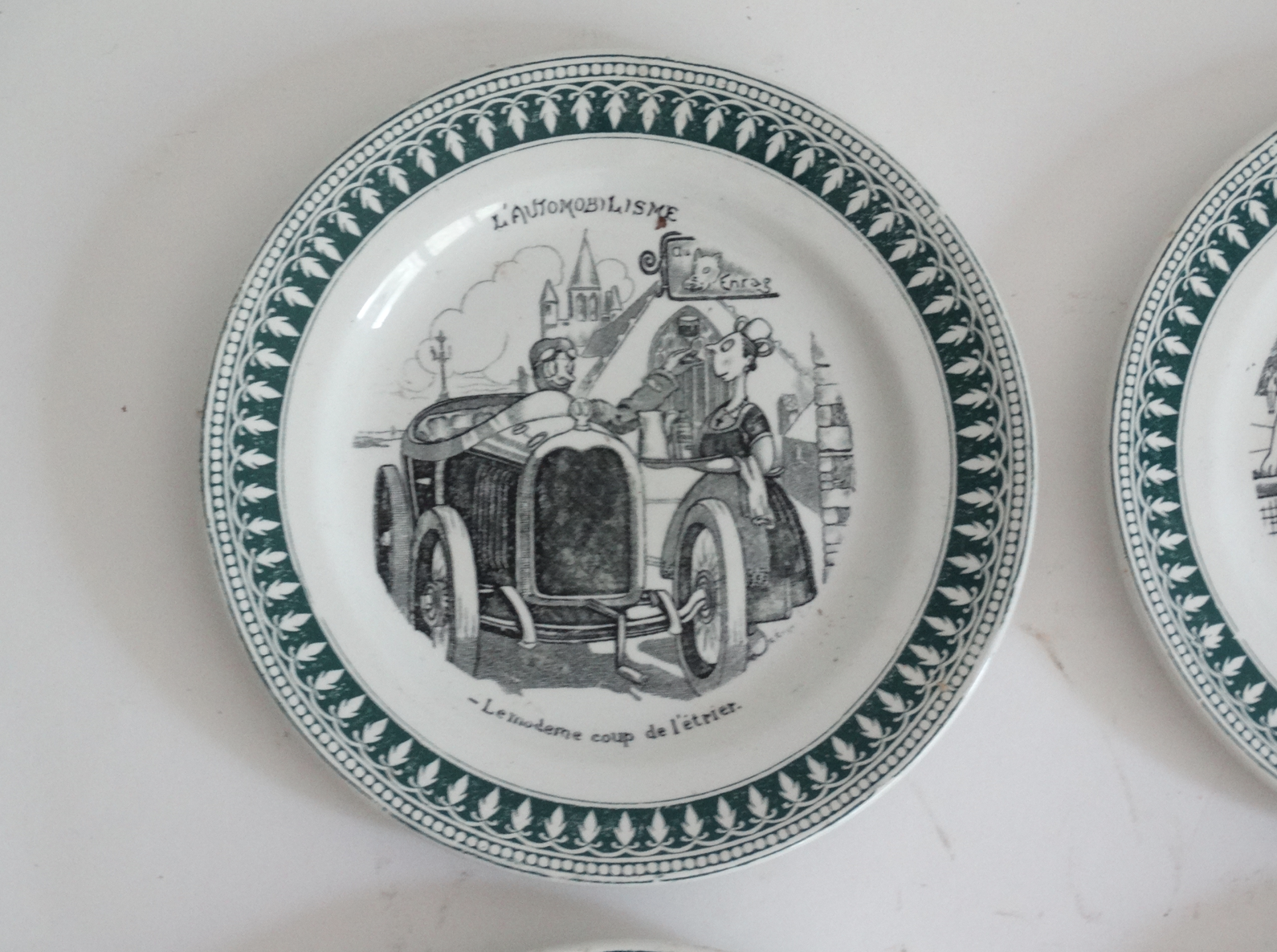 Four French faience sporting plates from St Amand factory, circa 1920. Includes Le Tennis, La Course Pied, La Boxe, L’Aviation, and l'Automobilisme. Located in Austin, Texas.