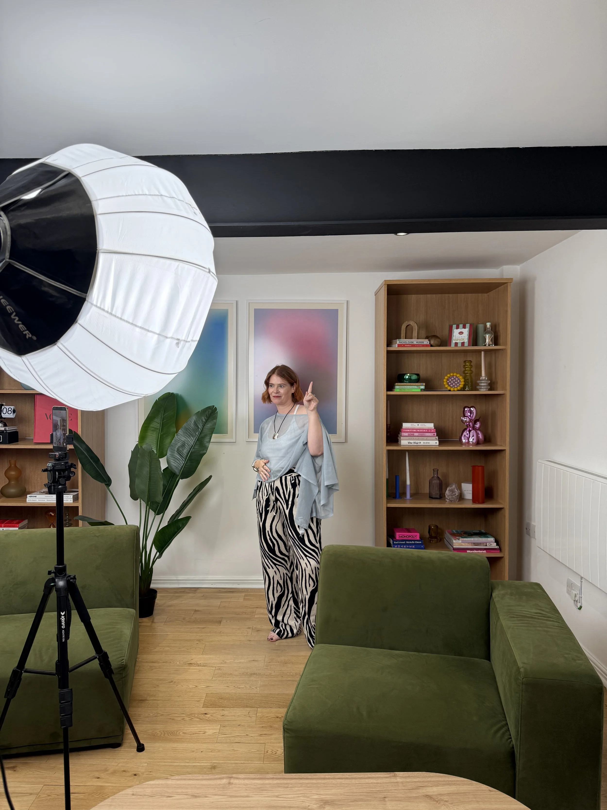 Creator filming short-form video at LND Studio, West London, with a lantern light and phone on a tripod