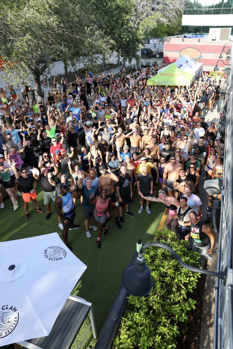 Pinellas Run Club group waving at a St. Petersburg meetup