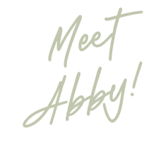 Text that says "Meet Abby!" in grey script on a black background.