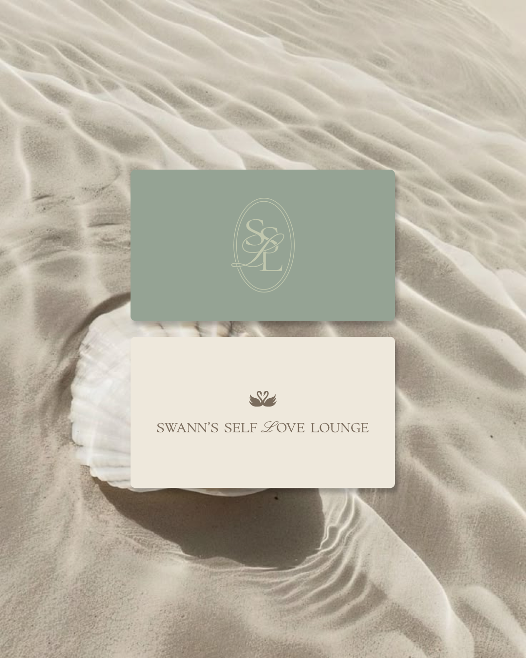 A beach scene featuring sand with ripples and shells, overlaid with two cards, one green with initials 'S S L' and one white with a swan logo and text 'Swann's Self Love Lounge'.
