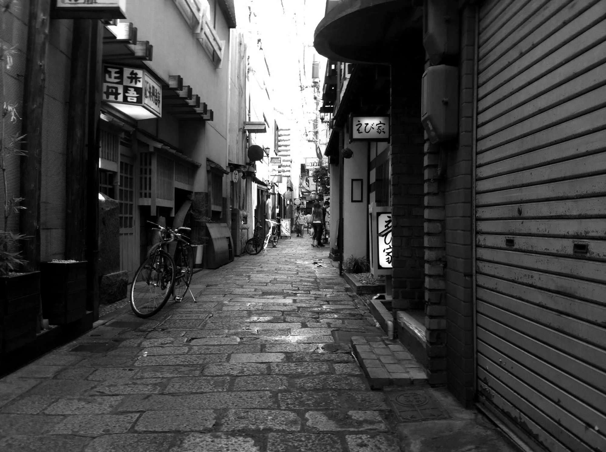 Black and white photo of a Tokyo sidestreet.