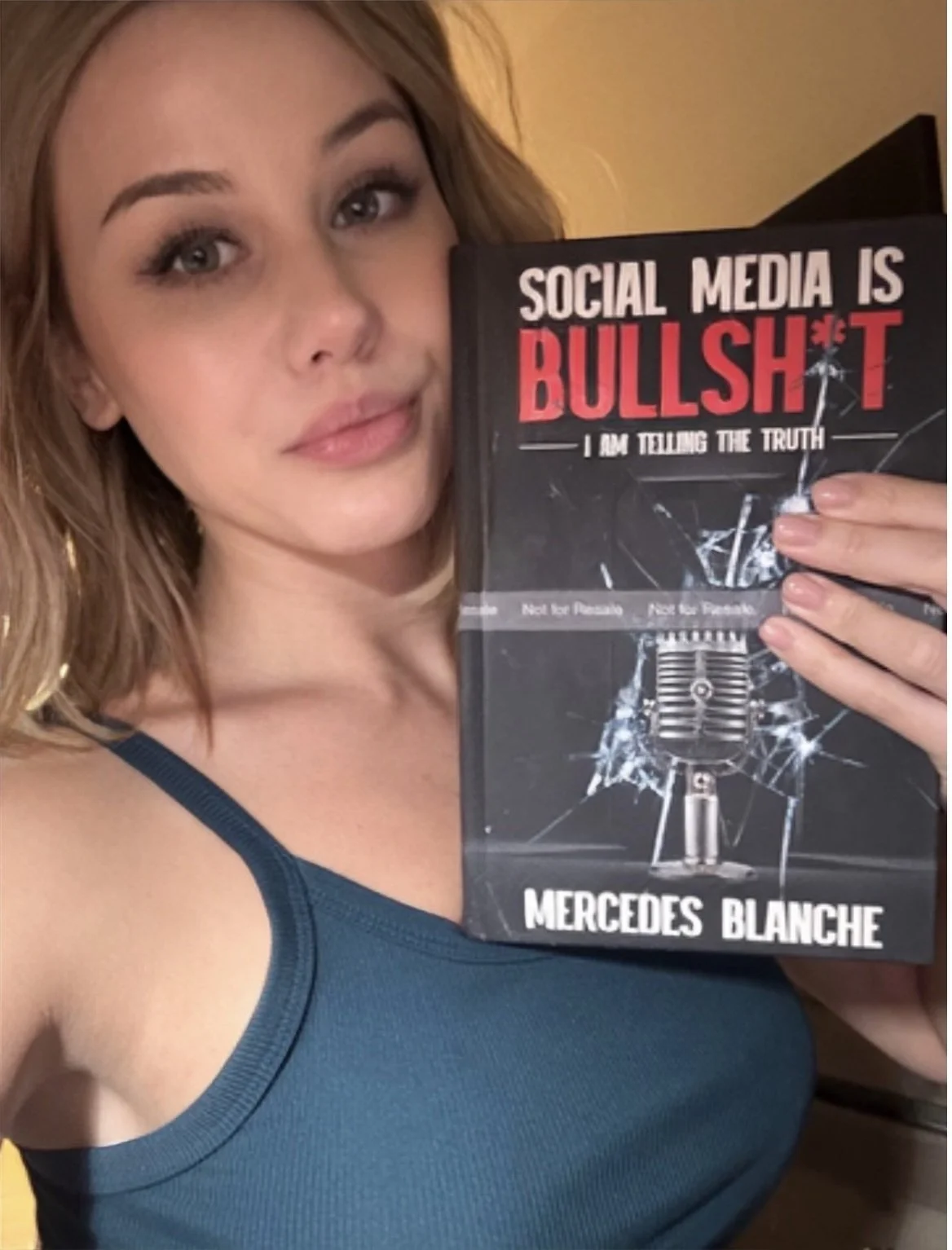 Mercedes Blanche holding her book Social Media is Bullsh*t