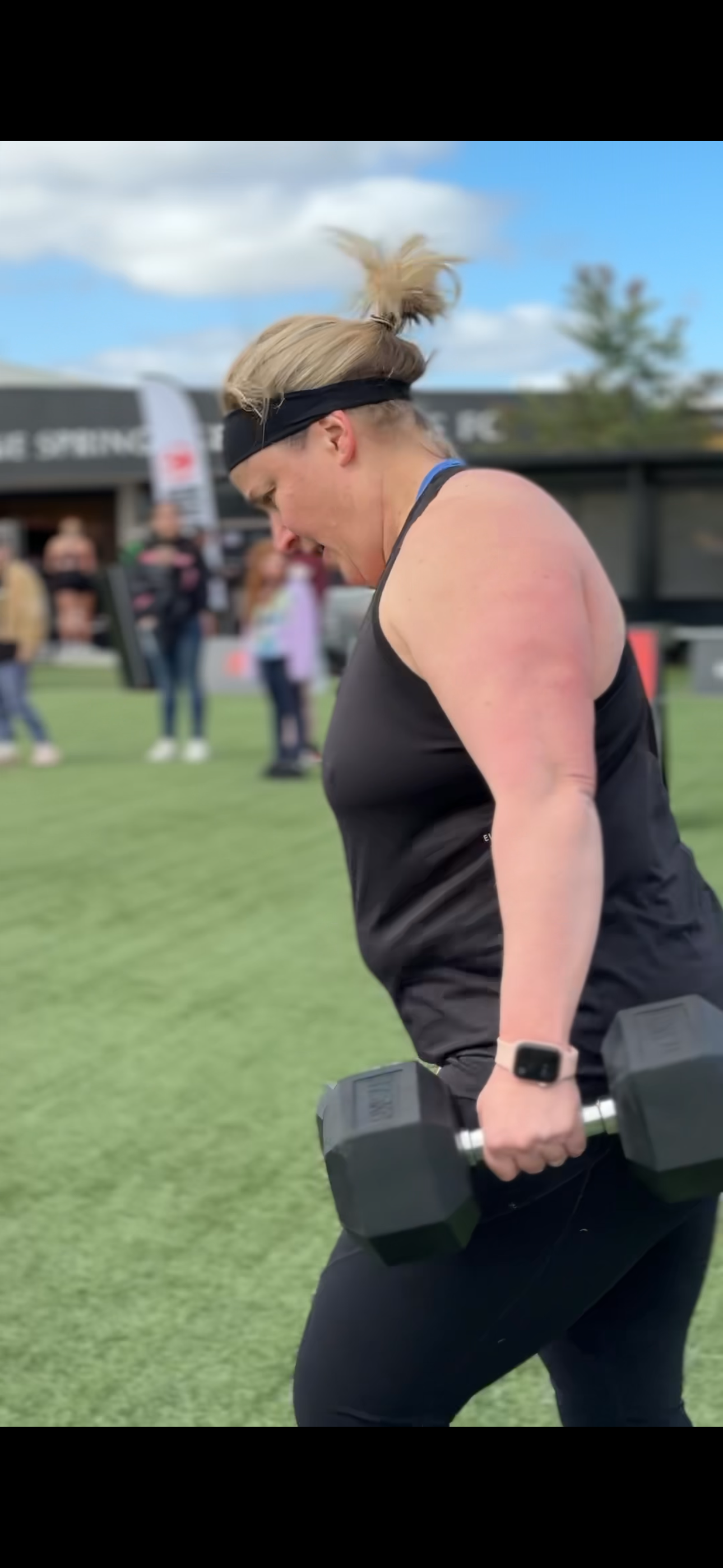 Person exercising outdoors with dumbbells