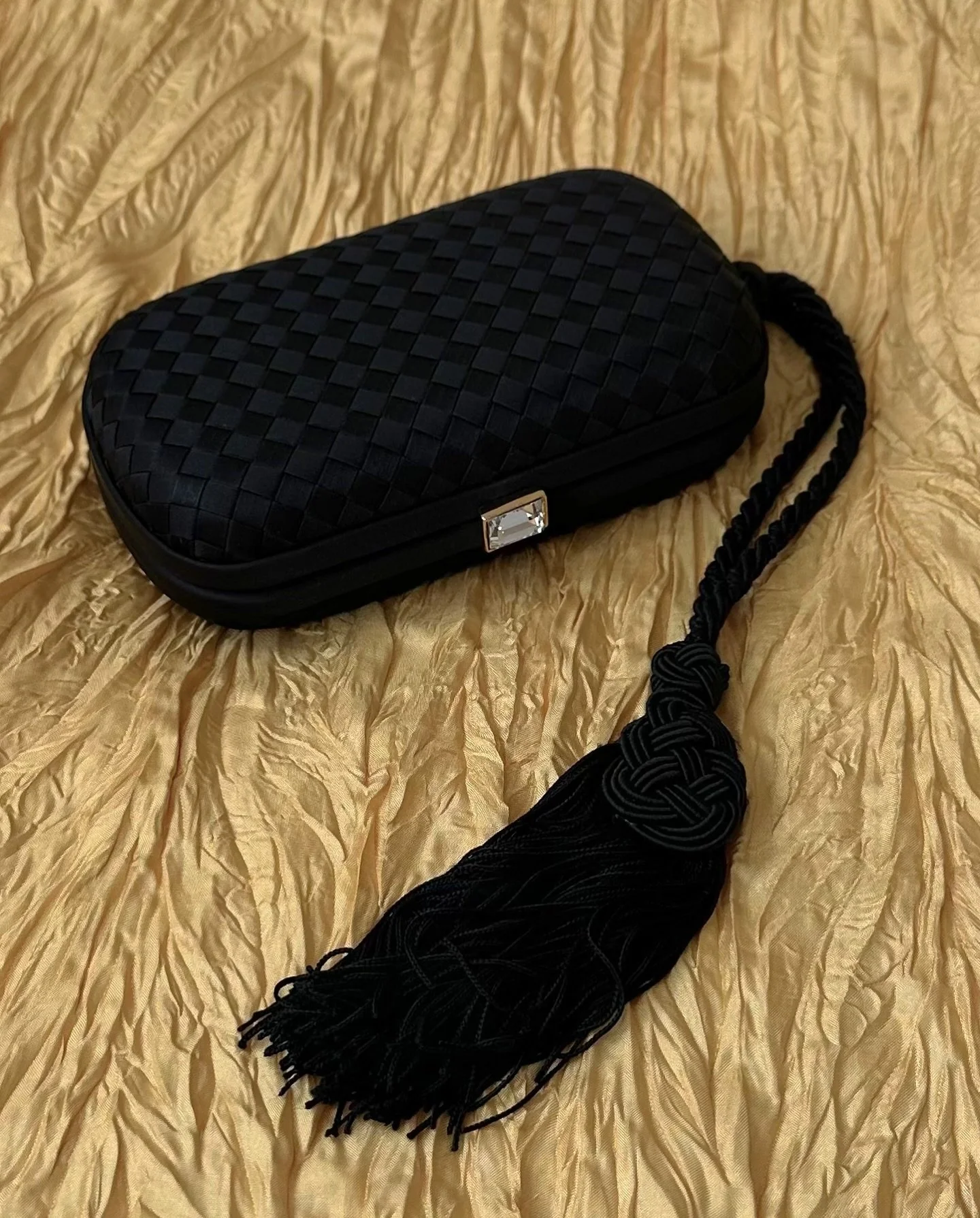 Bottega Veneta Satin Intrecciato Tassel Clutch 
Maison44.com
