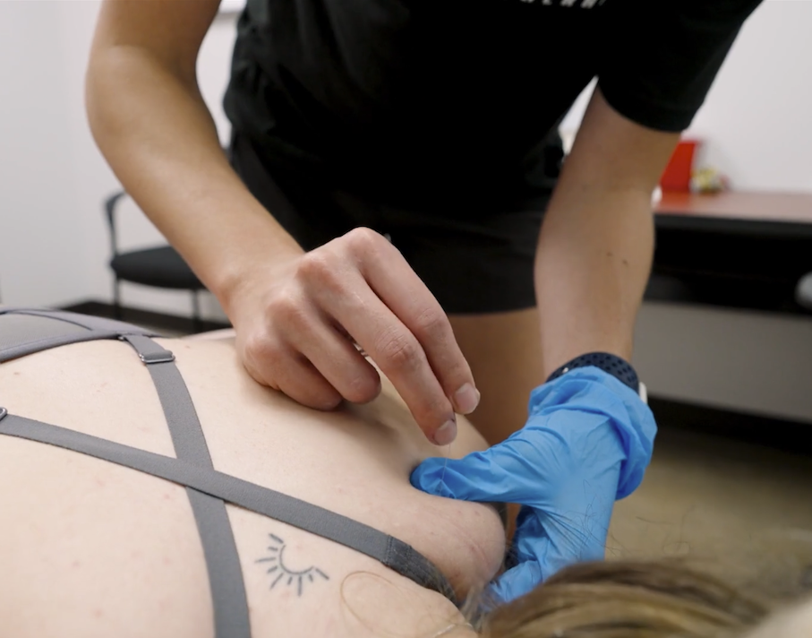 Patient working with a provider at a performance physical therapy clinic in Houston, TX