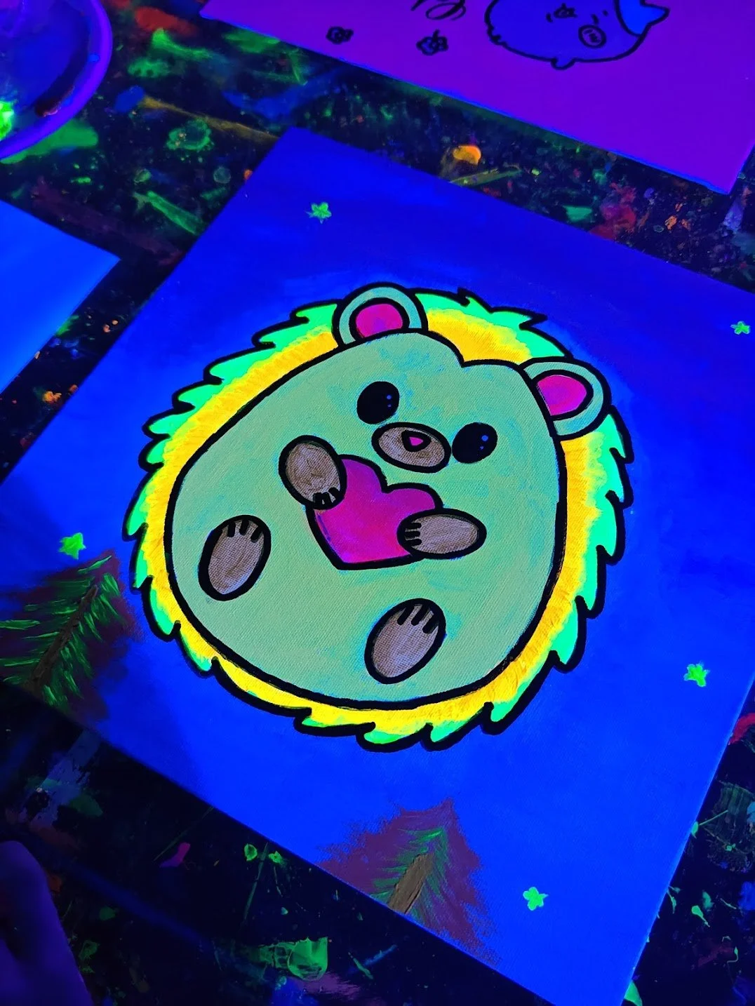 Cute cartoon bear with three eyes, holding a pink heart, surrounded by glowing green and yellow aura on a dark neon background.