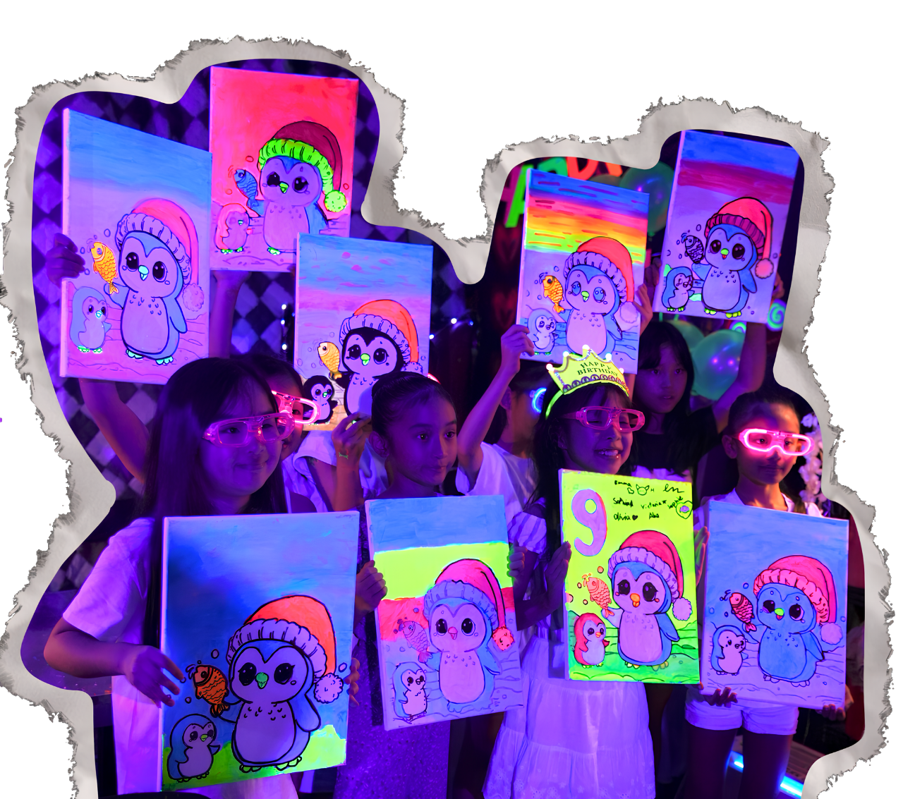 Kids at a glow-in-the-dark art event holding paintings of cartoon penguins wearing Santa hats with fish, under blacklight.