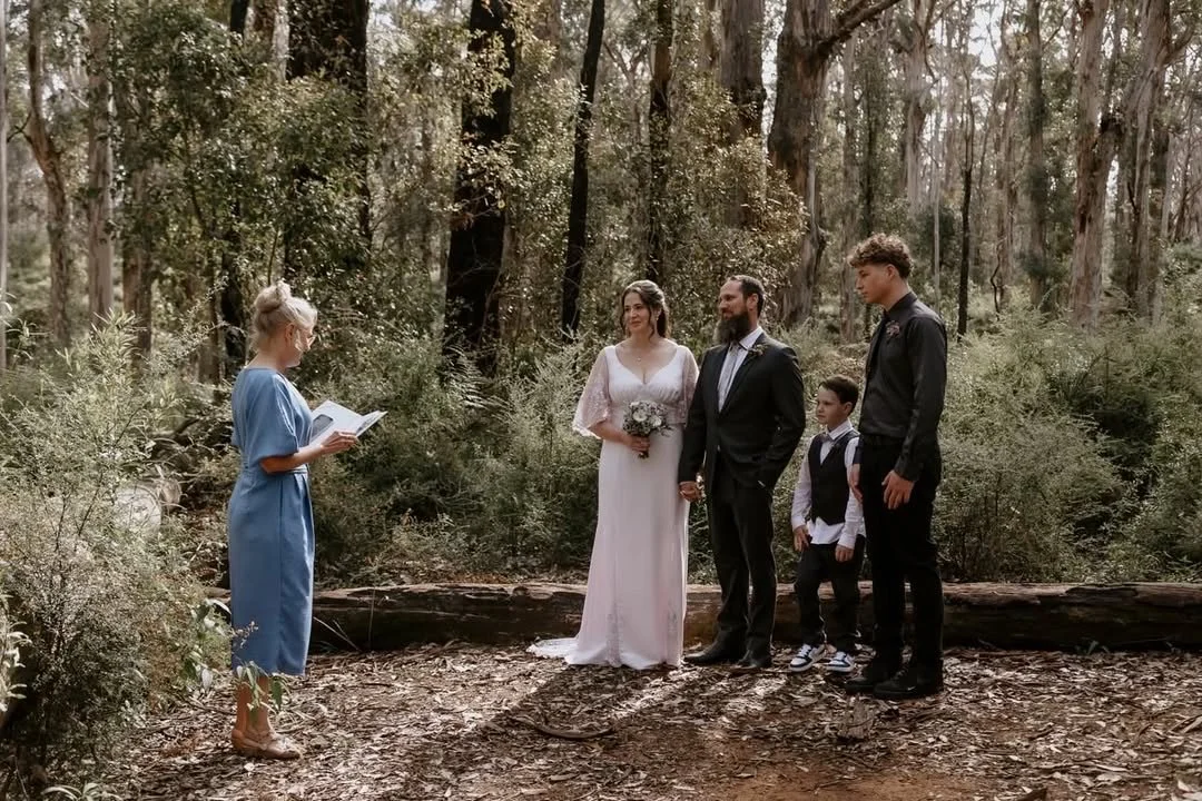 Couple getting married by celebrant in forest