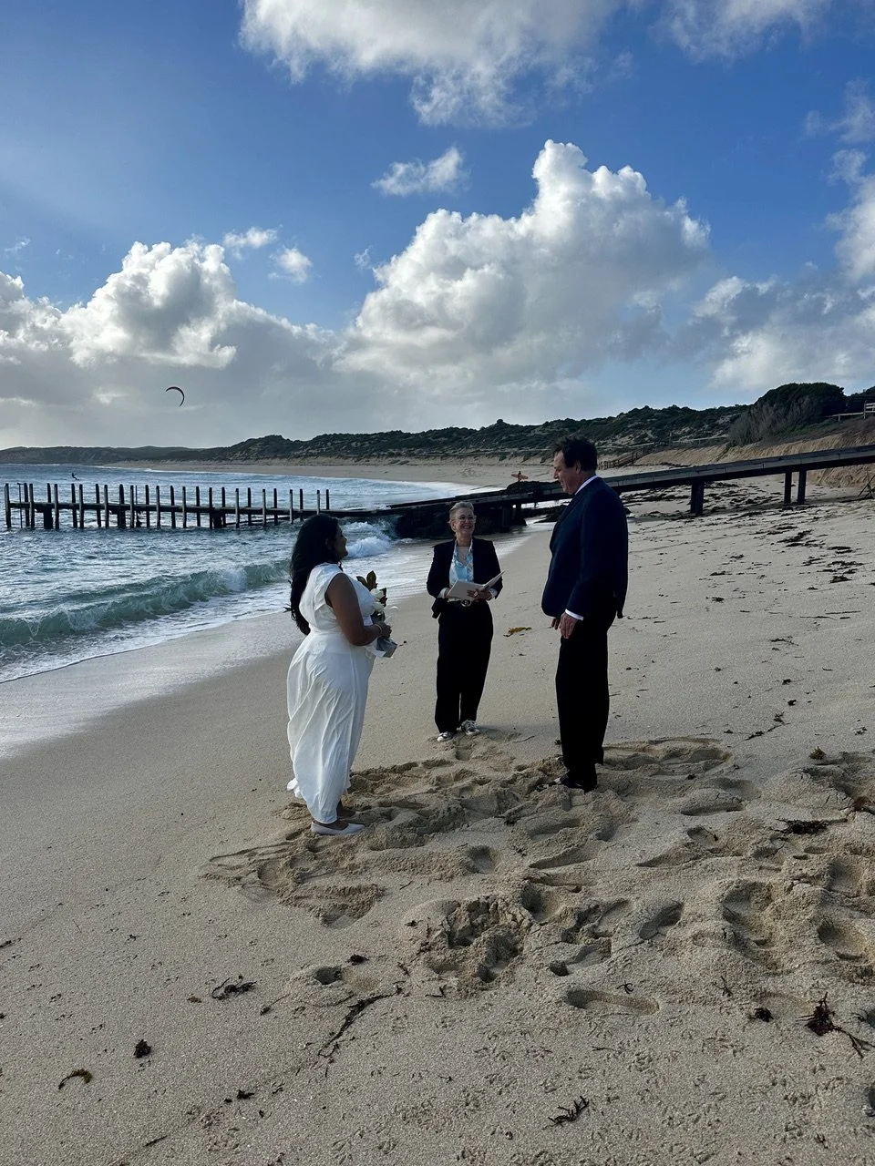 Celebrant marrying couple on beach
