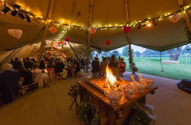 Tipi Poles stylied with fairy lights and hanging hearts