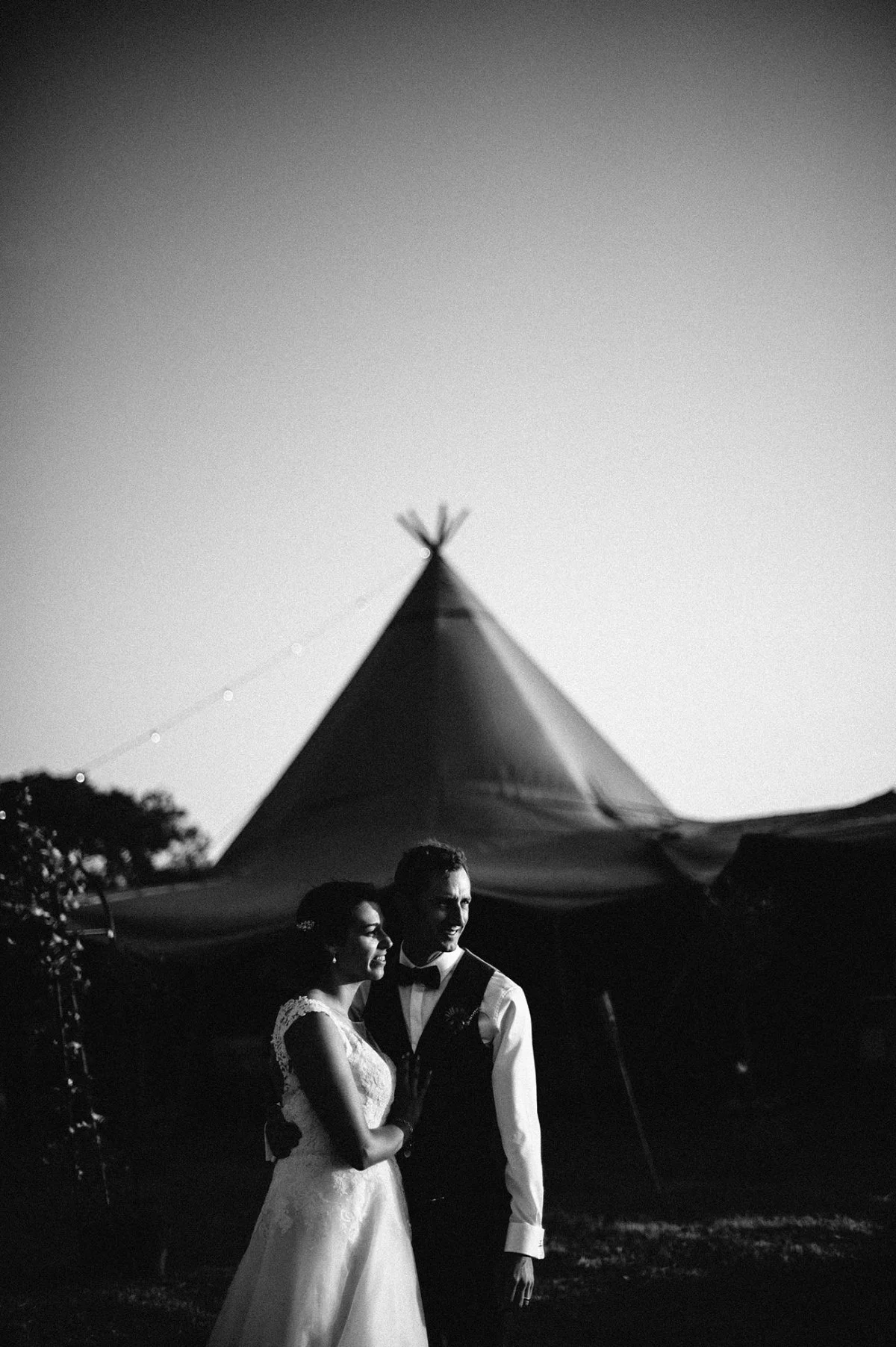 Couple outside tipi on their wedding day
