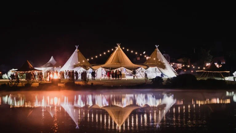 Tipi night shot of reflection on water