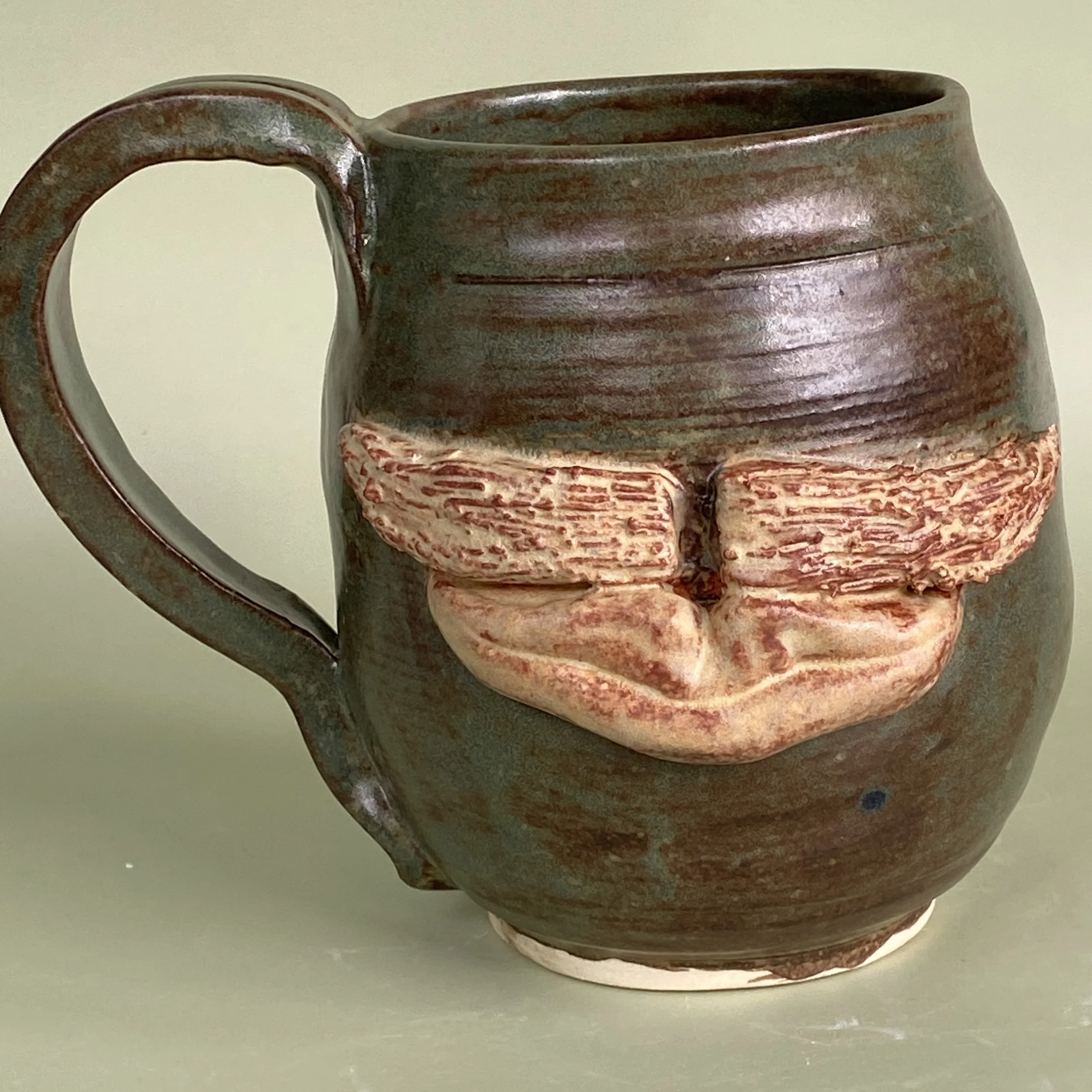 Mug glazed with Japanese Inspired Macha Glaze Embellished with a Tan Moustache