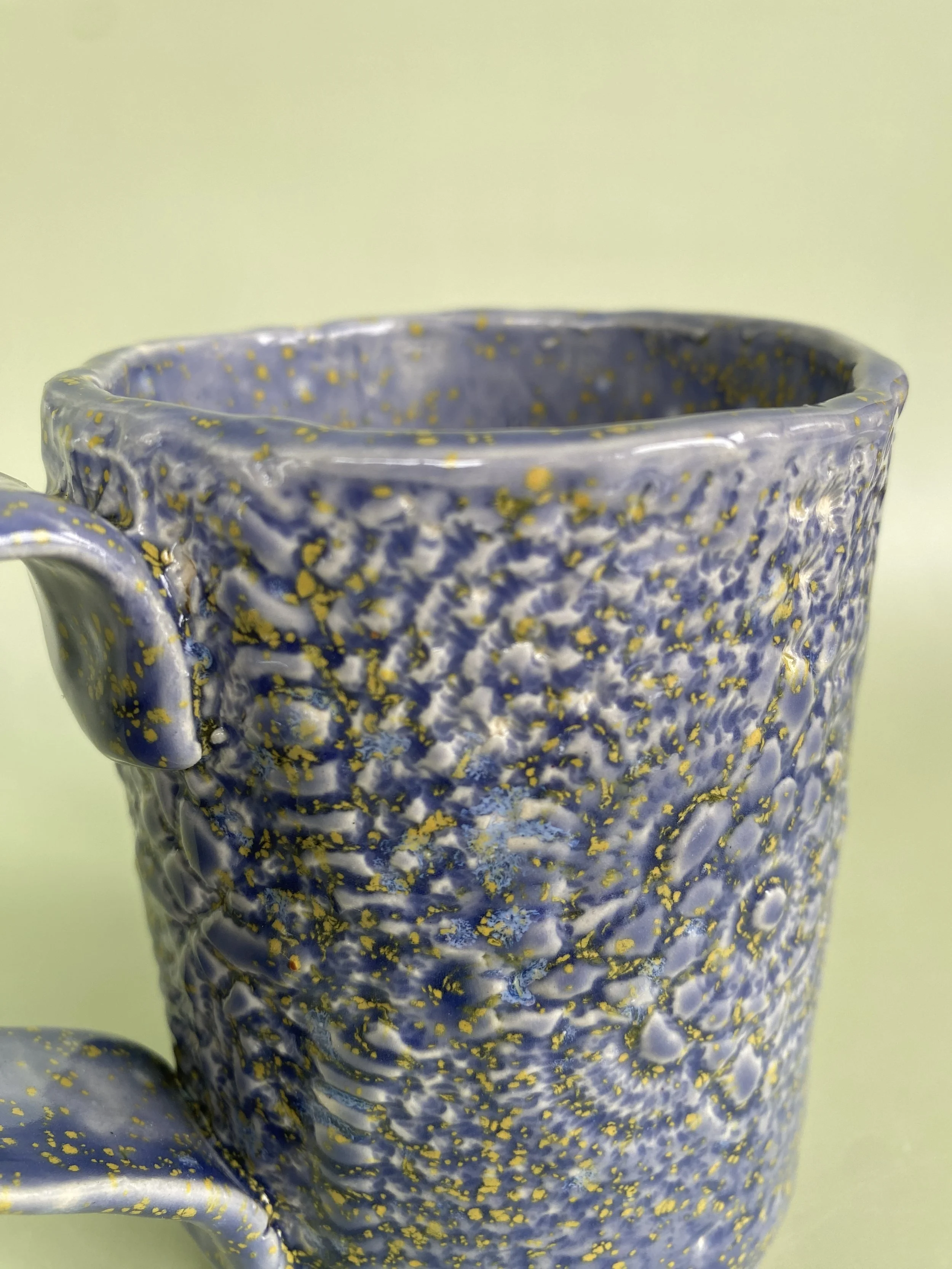 Set of purple and yellow hand-built mugs