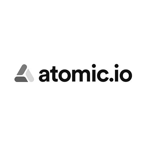 Black and gray logo for atomic.io with a stylized triangular icon to the left of the text.