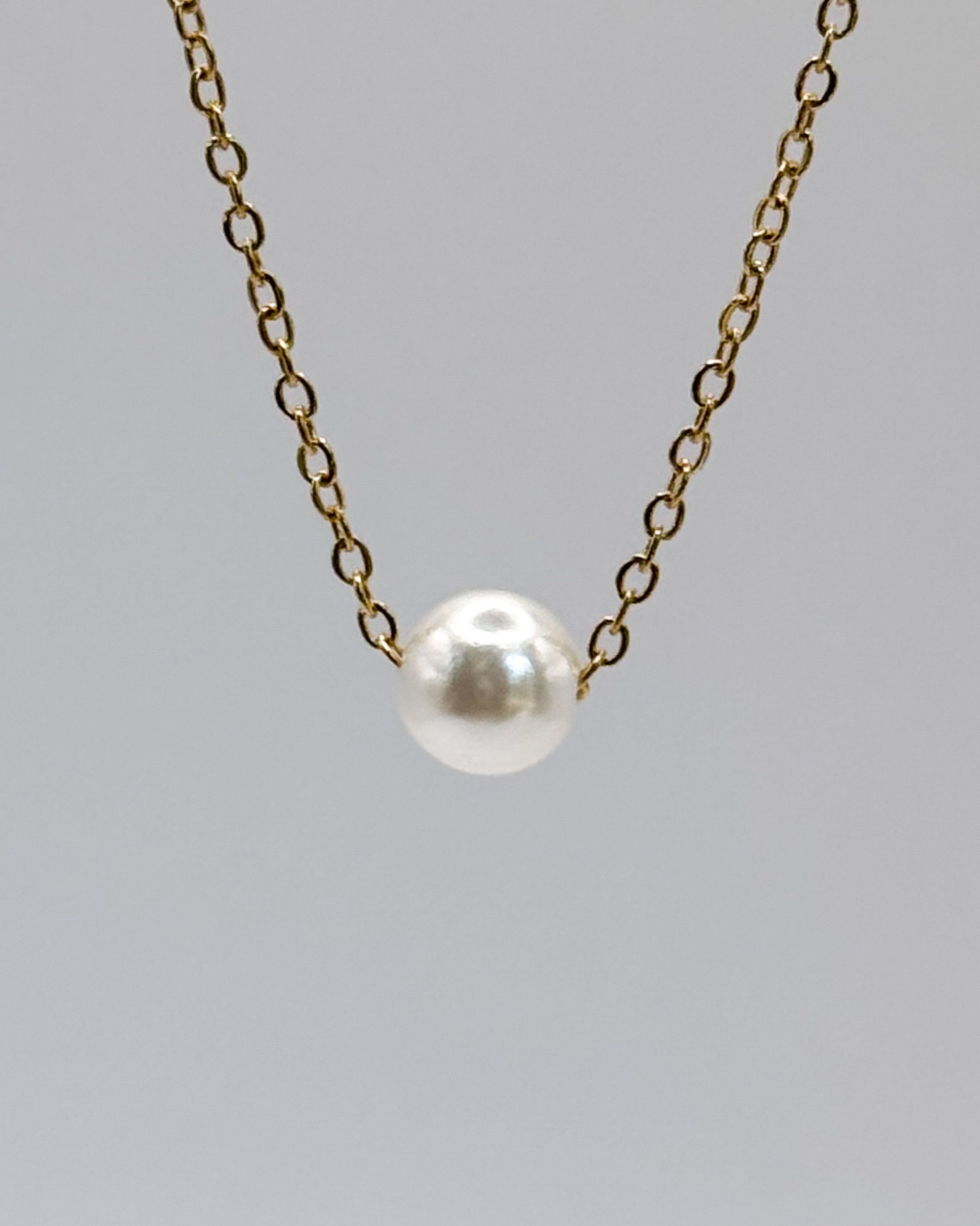 Inma necklace by Emilia Burk – gold chain with floating pearl-look charm, waterproof and tarnish-free