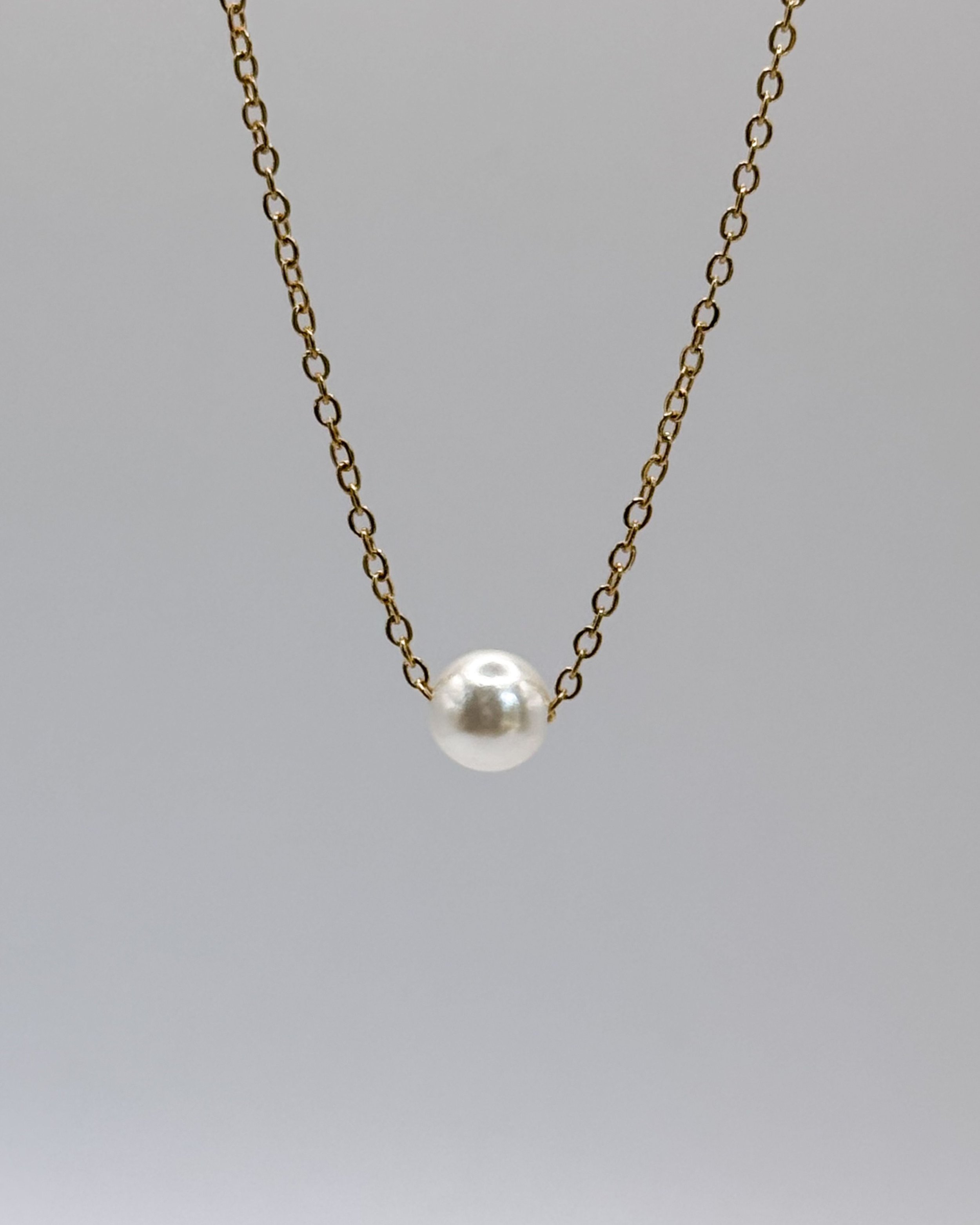 Inma necklace by Emilia Burk – gold chain with floating pearl-look charm, waterproof and tarnish-free