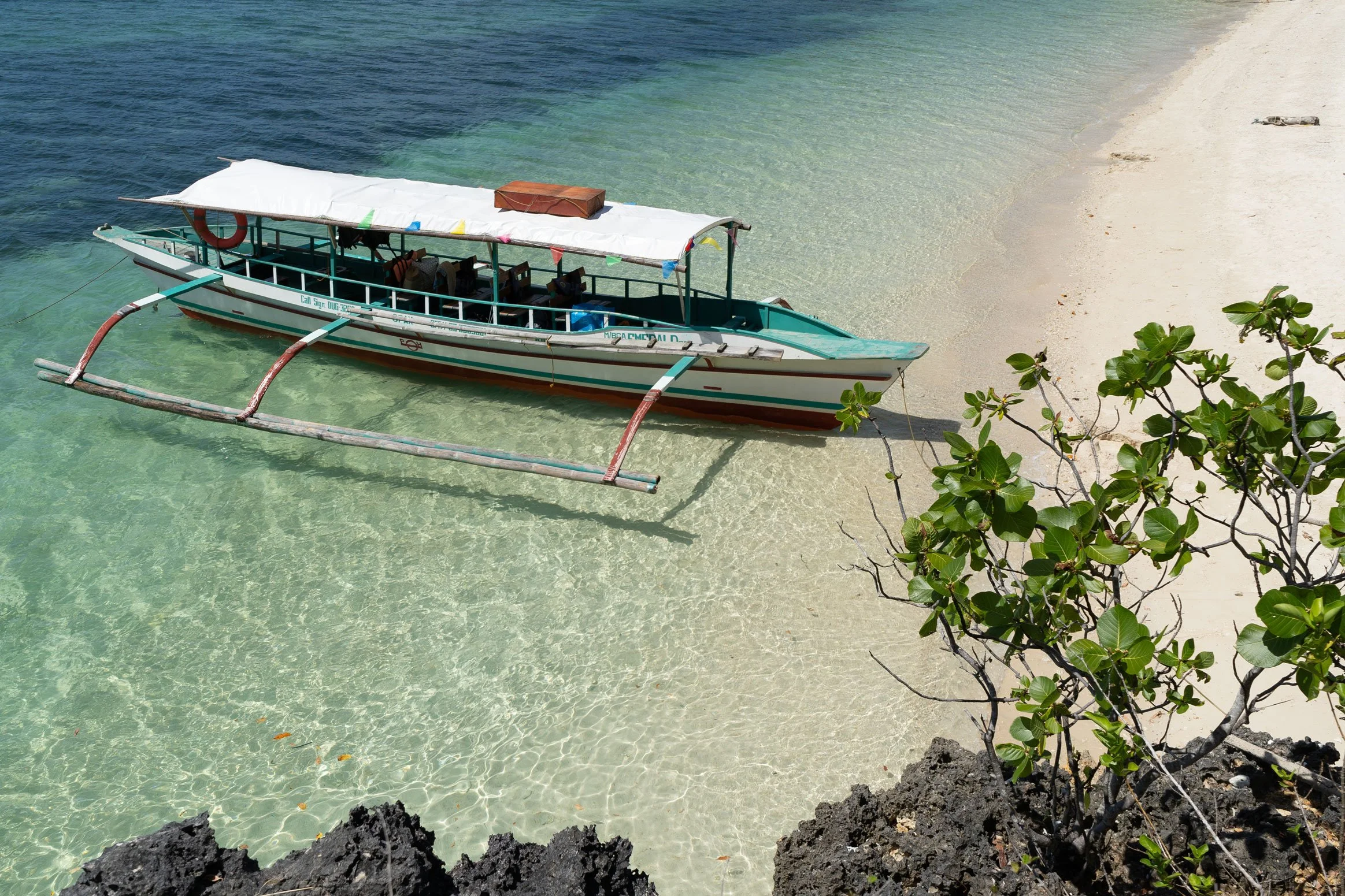Island hopping boat ride in Guimaras with crystal clear water and tropical scenery