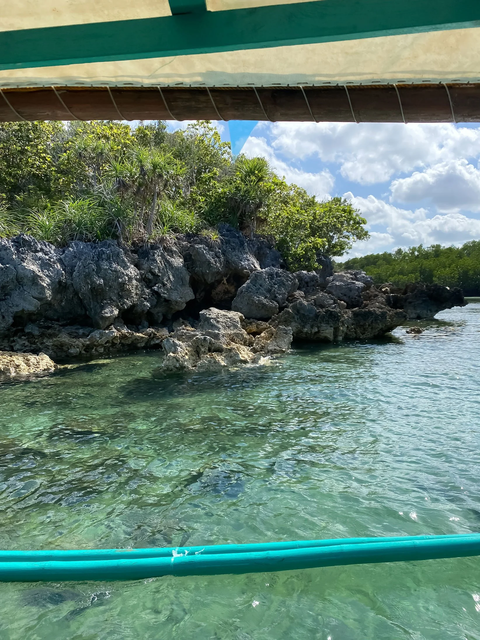 Guimaras island hopping boat view with clear blue water and limestone islands
