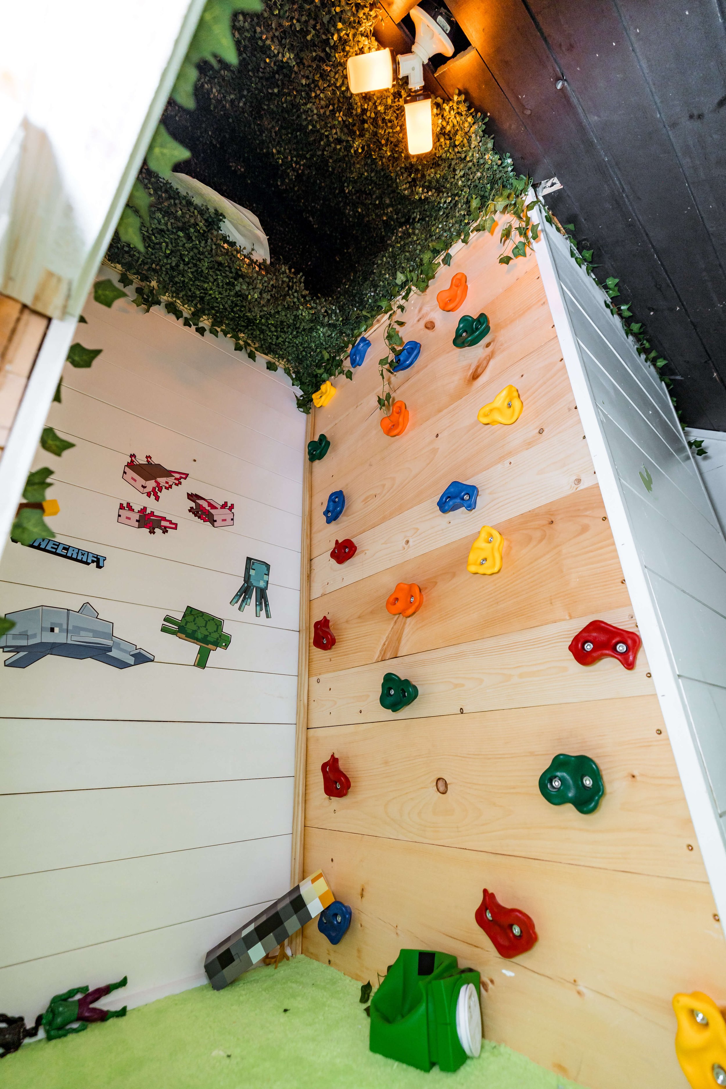 Minecraft-style playroom area with rock climbing wall.