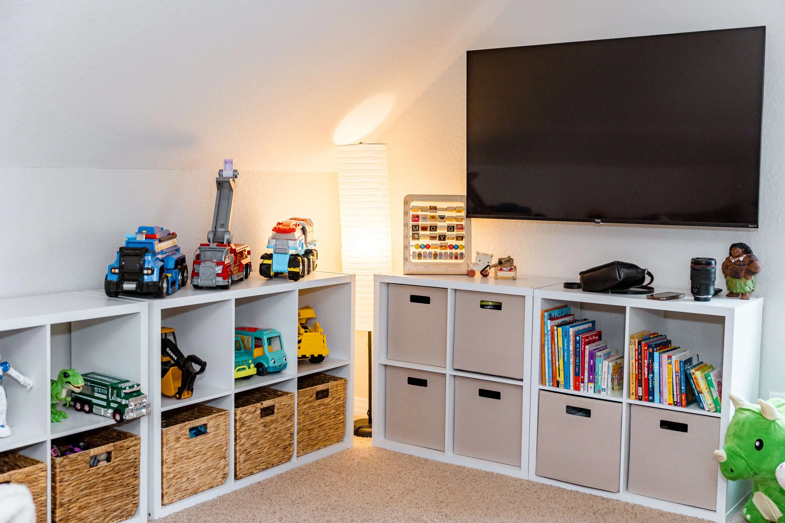 Playroom shelves and bins arranged in a clean, organized system.