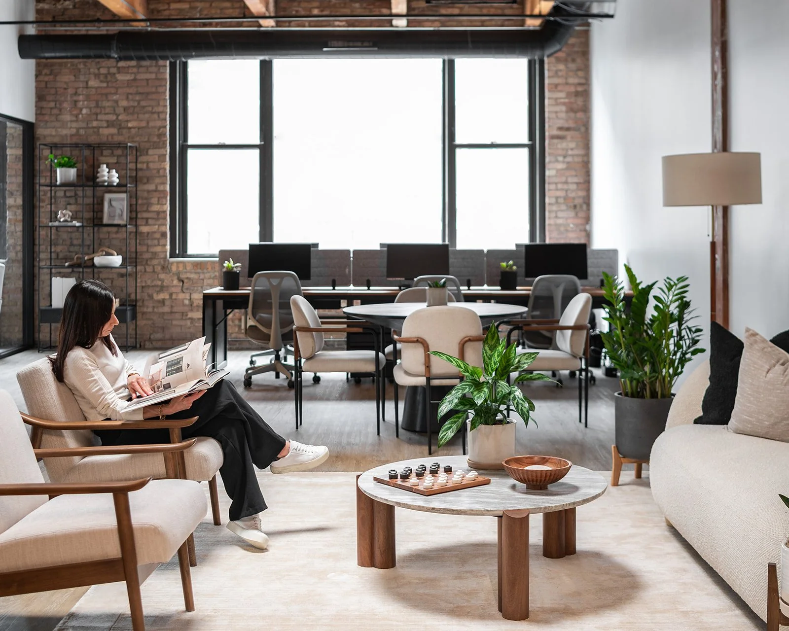 Designer reading a book in a Chicago executive office space