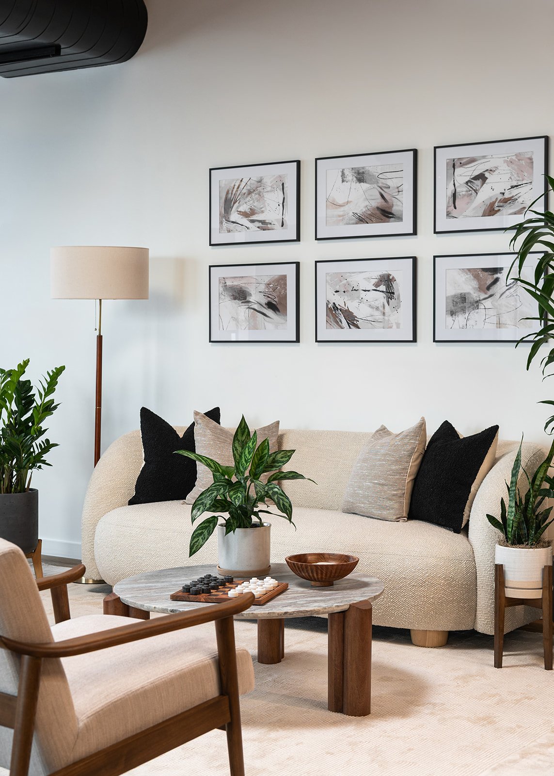 Executive office lounge seating area in a Chicago loft designed for a retail leadership team with modern furnishings and layered textures.
