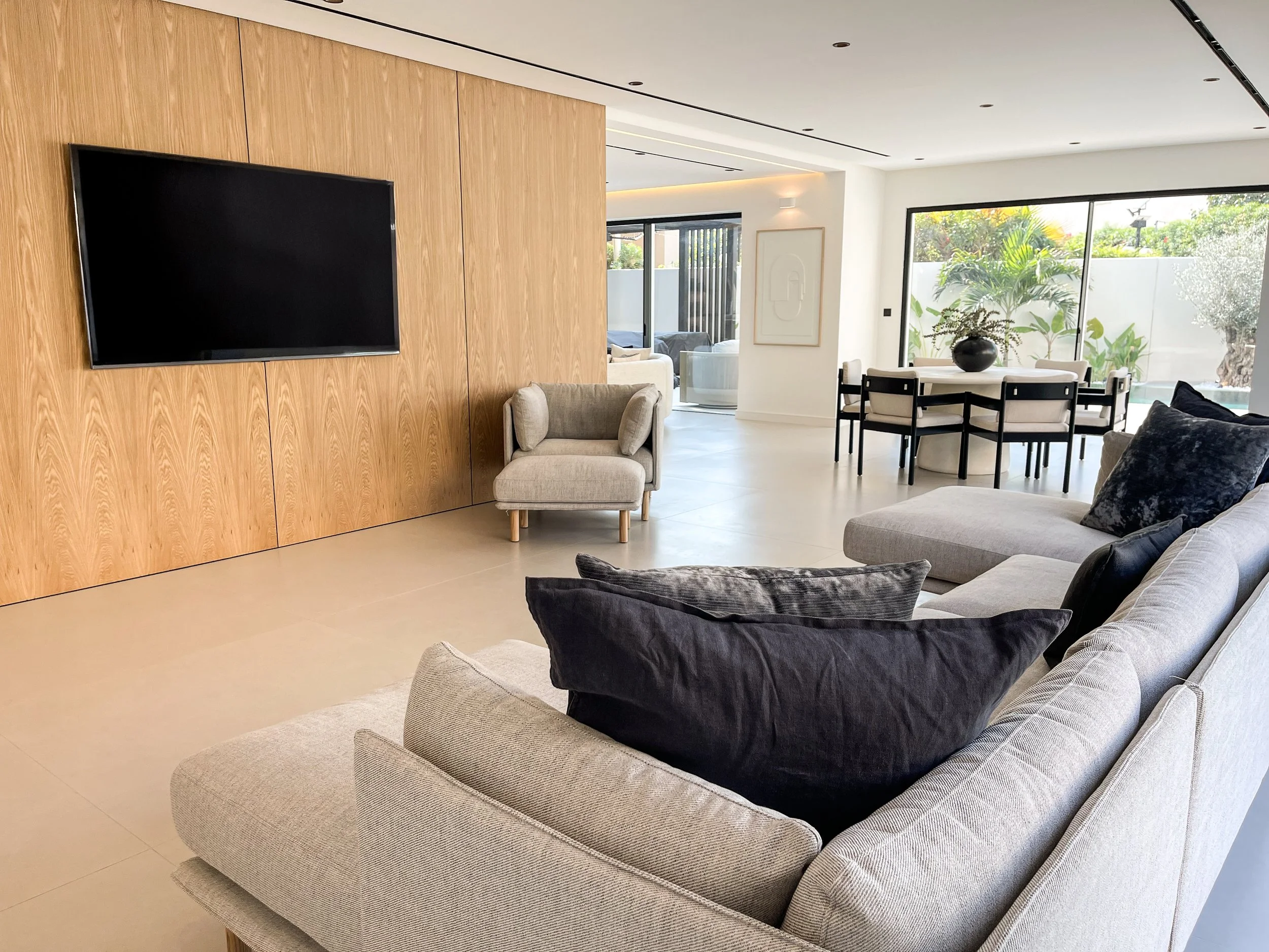 Stylish TV area in Ranches 1 villa with a contemporary entertainment unit, plush seating, and a cozy ambiance for relaxation and entertainment.
