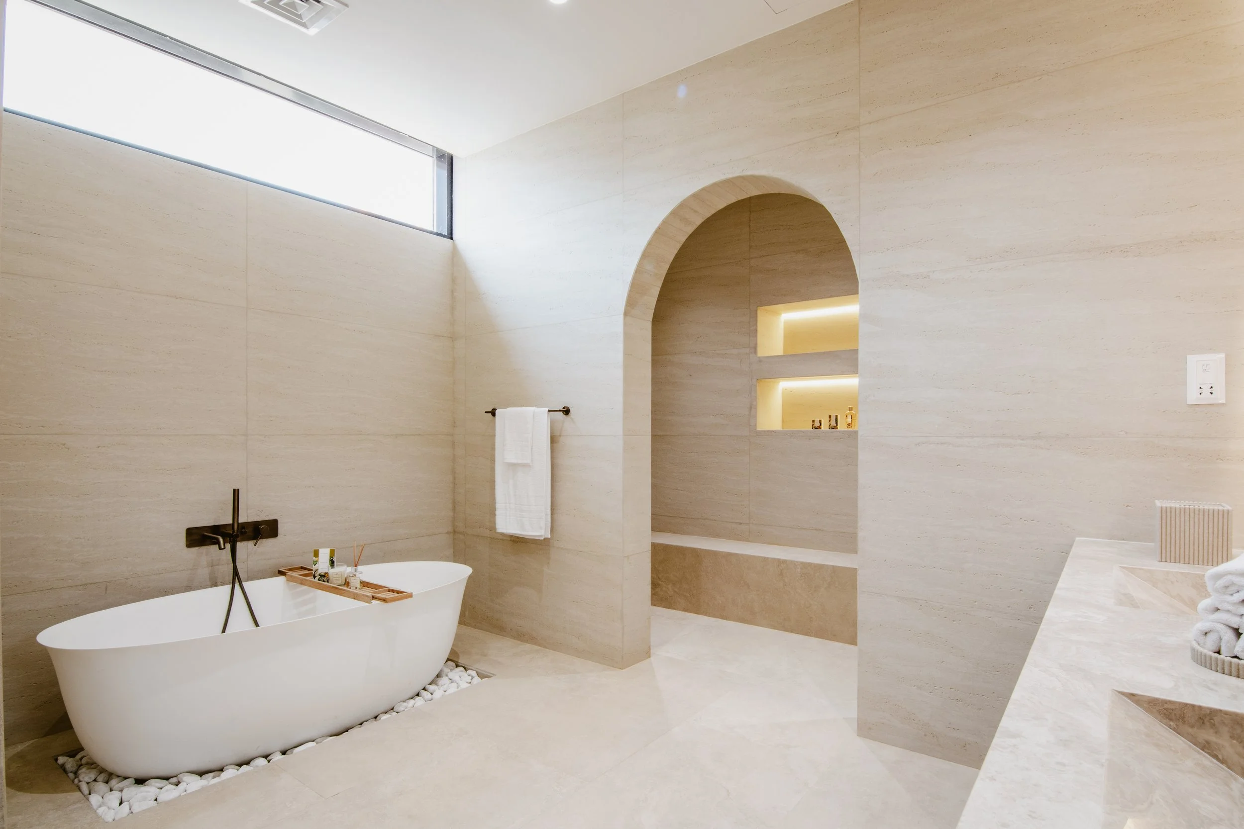 Modern powder room with marble countertops, gold fixtures, and ambient lighting."  Guideline: Clearly describe the main features of the bathroom to assist visually impaired users.