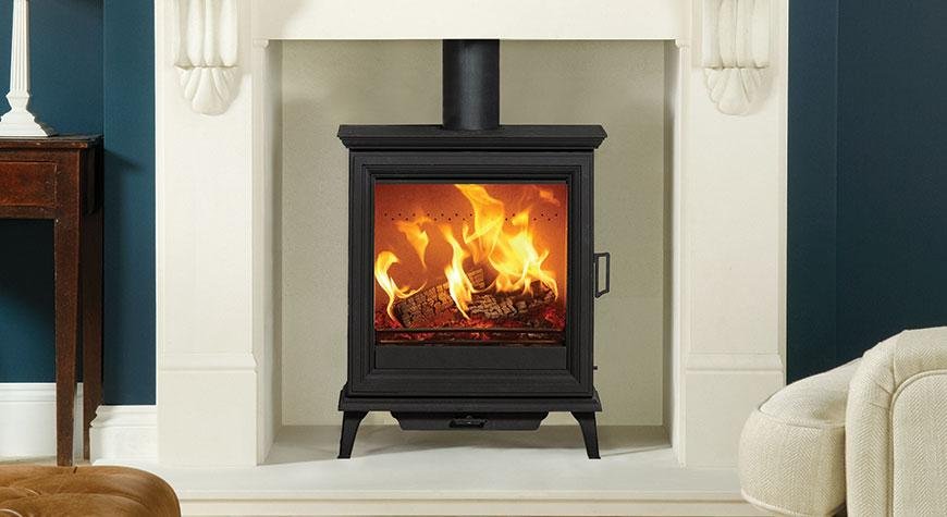 Sheraton-5-Wide-multi-fuel-Ecodesign-stove-burning-logs-with-Victorial-Corbel-mantel-in-Natural-Limestone.jpg