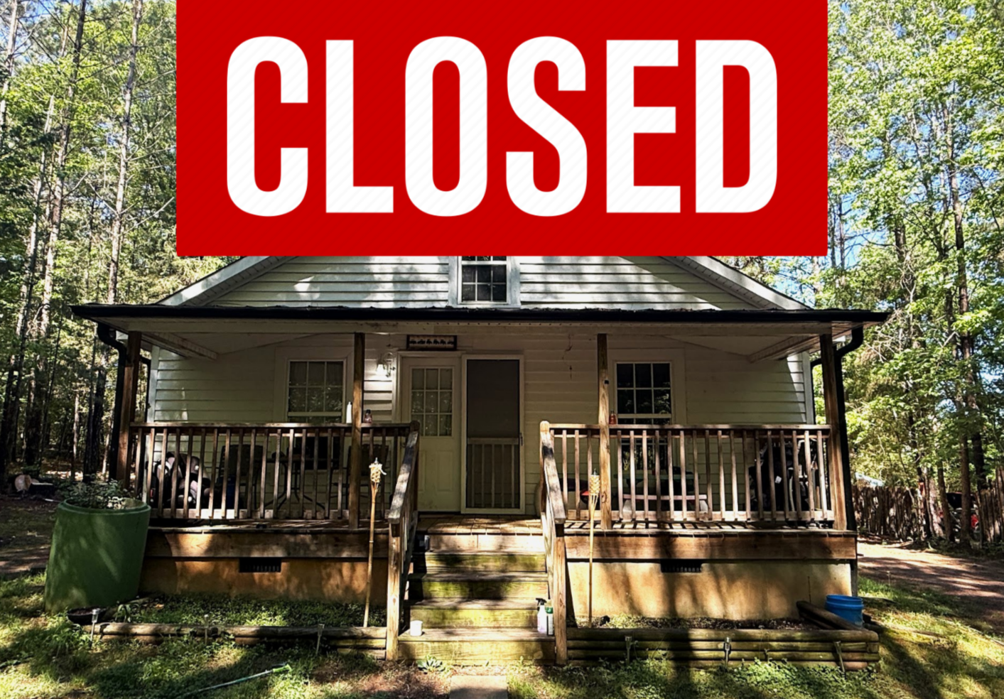 House with white siding, a porch, surrounded by trees, and the words "Under Contract" overlaid.