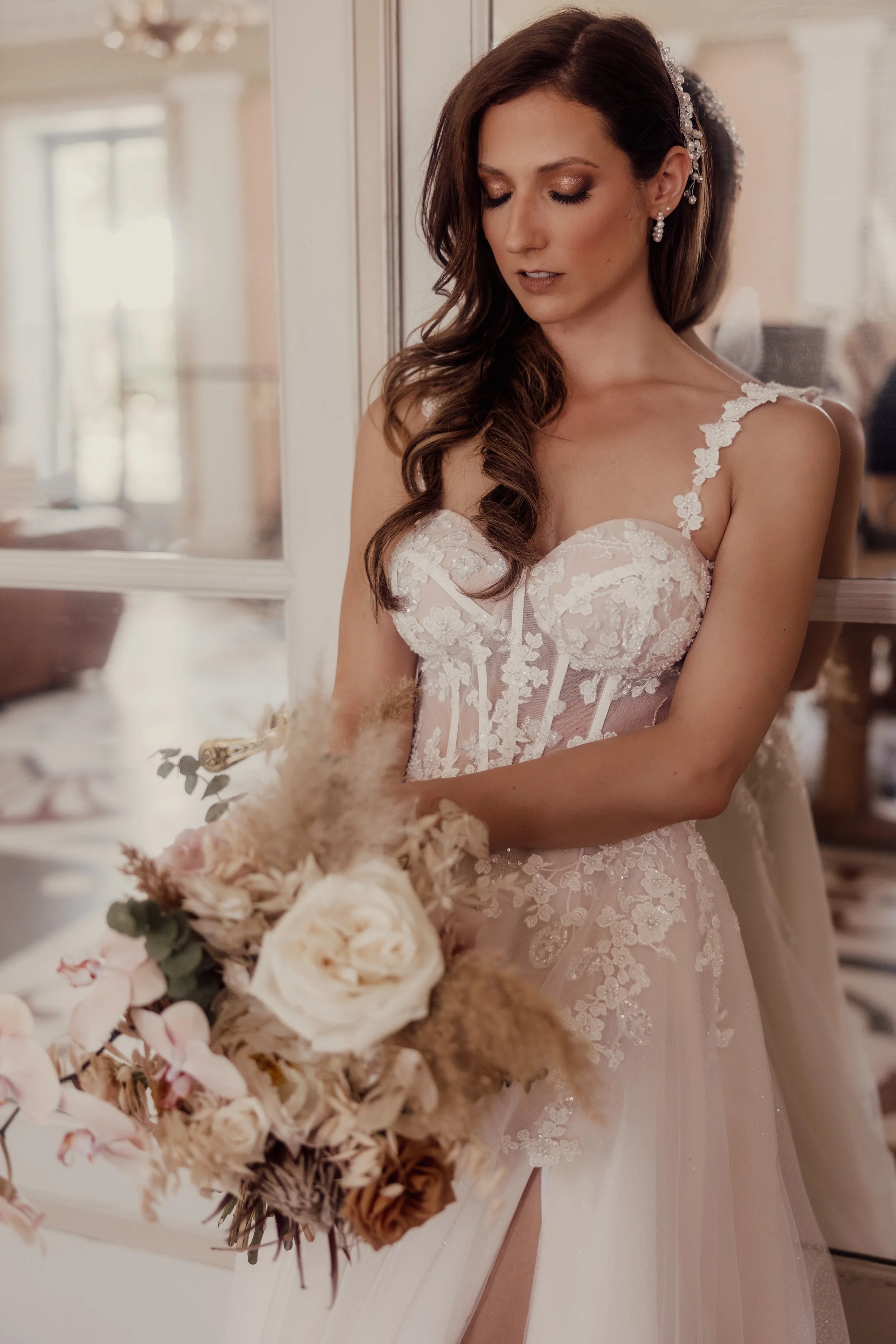 Bride in lace wedding dress holding bouquet