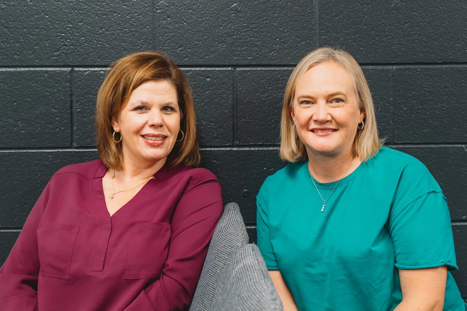 Two women sitting together and smiling